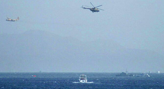 An Egyptian Hercules military aircraft (L) and a helicopter can be seen circling three miles off Sharm El Sheikh. (File/AFP)