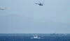 An Egyptian Hercules military aircraft (L) and a helicopter can be seen circling three miles off Sharm El Sheikh. (File/AFP)